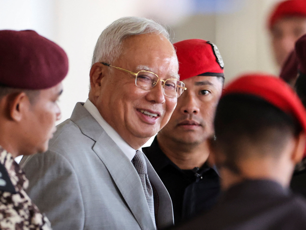 Najib Razak is surrounded by prison guards as he arrives at the High Court in Kuala Lumpur for his attempt to be granted house arrest. Photo: Reuters