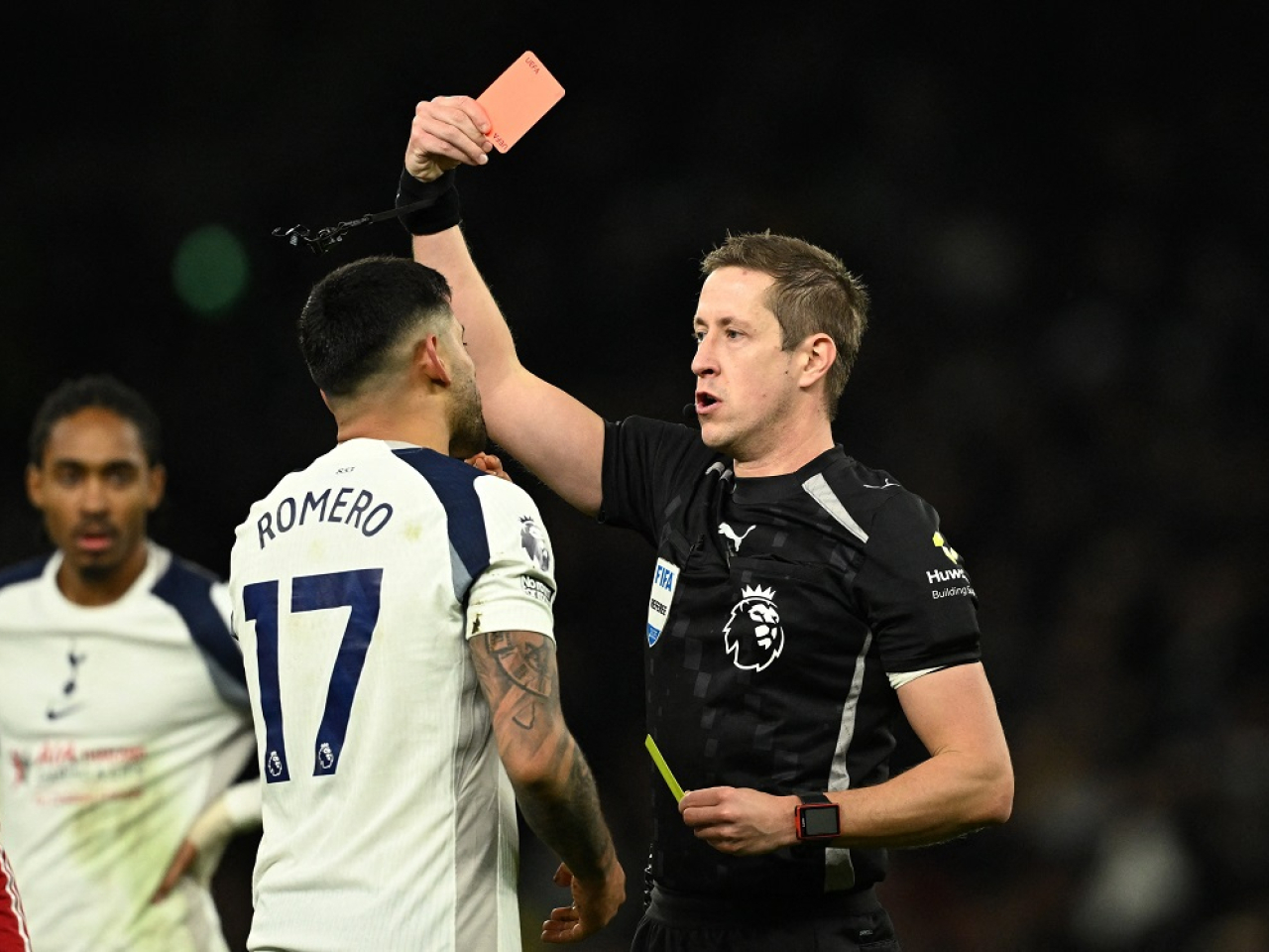 Cristian Romero gets his marching orders at Anfield from referee John Brooks. Photo: Reuters