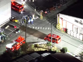 Emergency vehicles gathered outside the factory in Mishima after reports of the knife and liquid attack broke out. Image: Nippon TV via Reuters