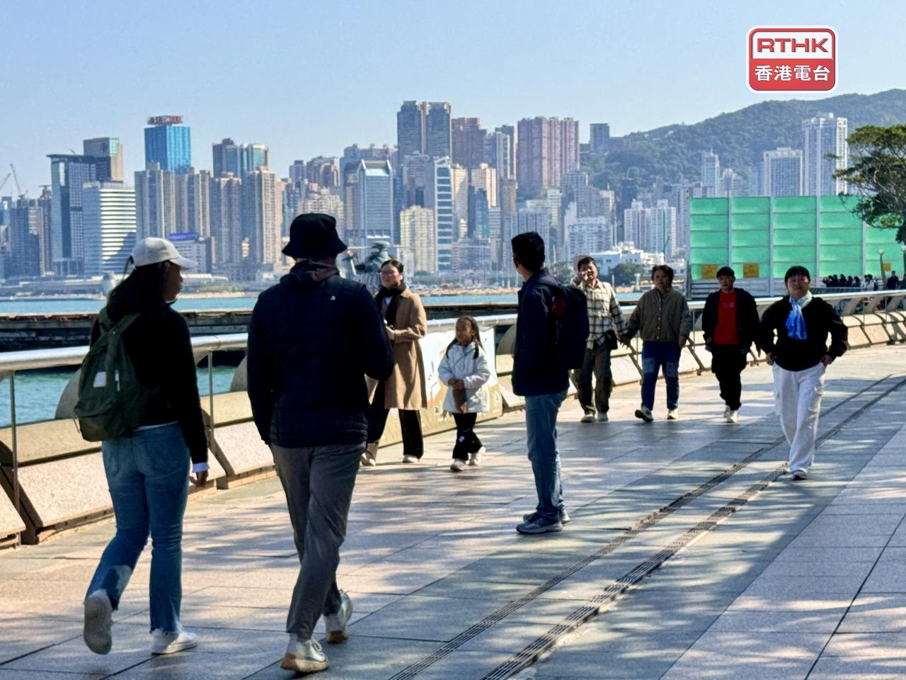 People bundle up in layers and scarves as a cold snap grips the city. Photo: RTHK