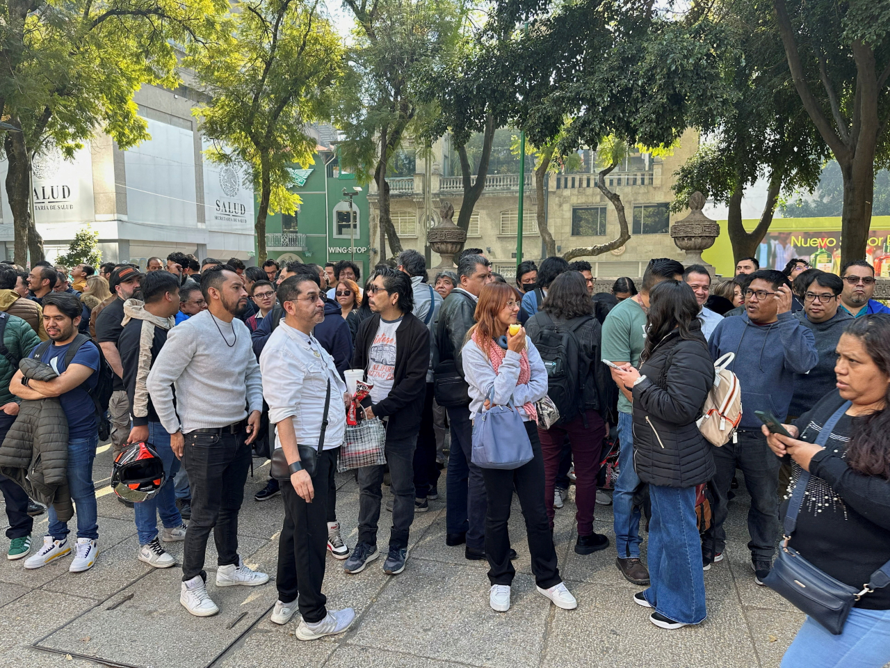 People wait on the street in Mexico City after the earthquake alarm sounded. Photo: Reuters