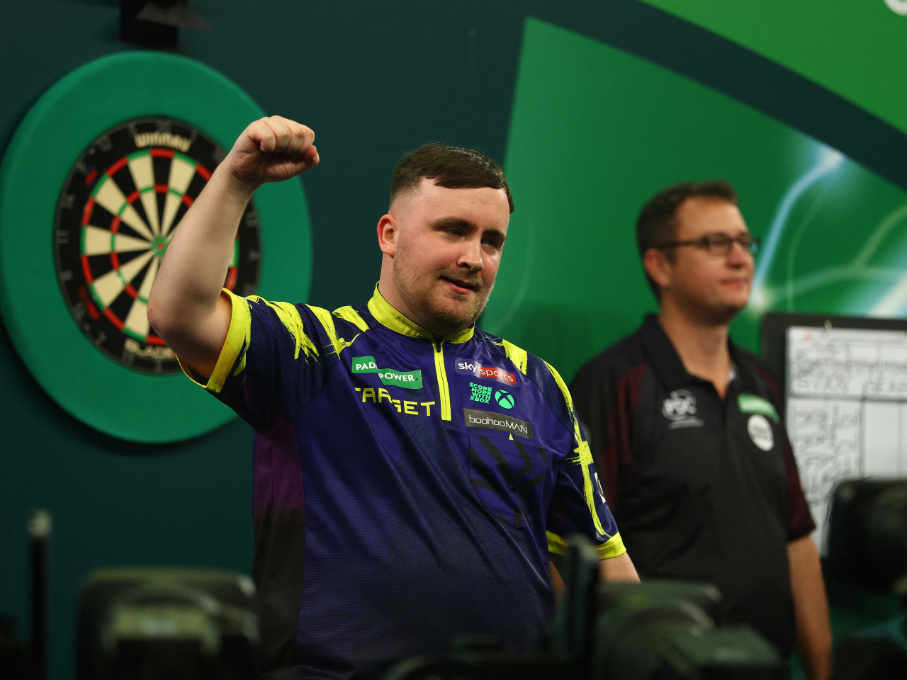 Luke Littler is all pumped up after beating Ryan Searle to make it to his third consecutive World Darts Championship final in London. Photo: Reuters