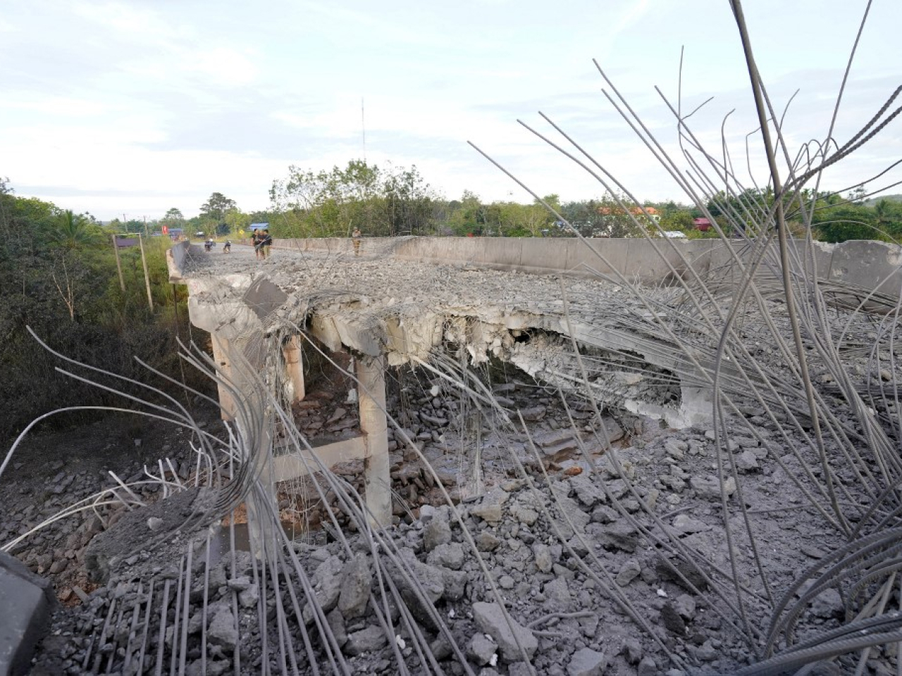 People stand on a damaged bridge in Pursat in Cambodia, following clashes in December along the border with Thailand. File photo: AFP