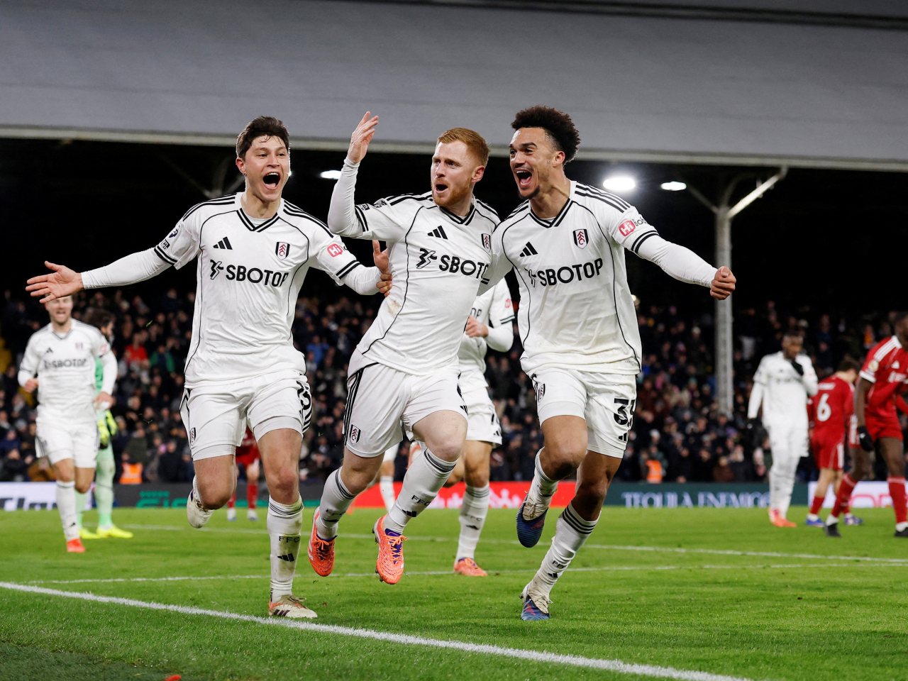 Fulham's Harrison Reed, centre, bagged his first goal in three years to cap off a dramatic finish at Craven Cottage. Photo: Reuters