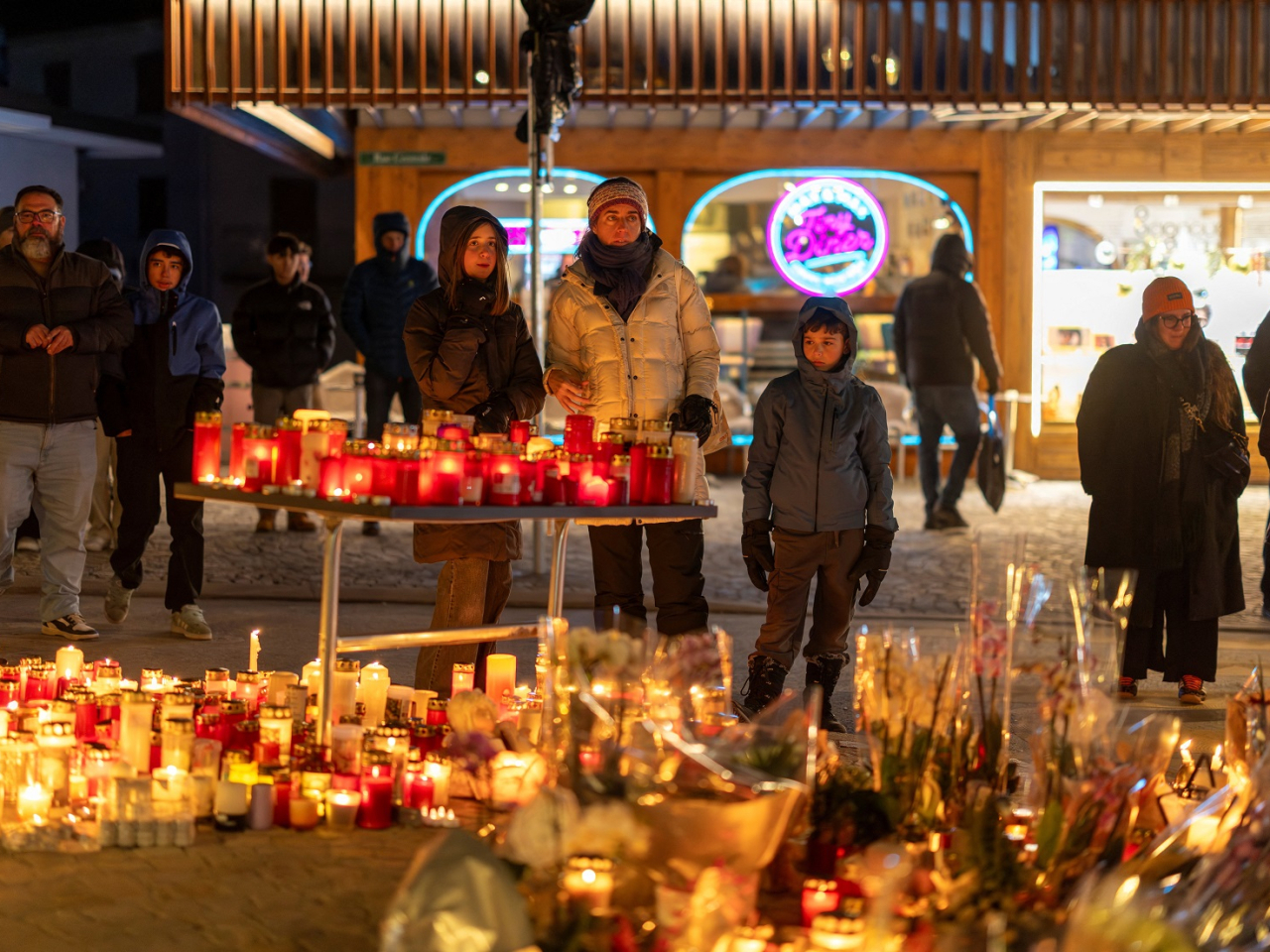 People visit a makeshift memorial outside the "Le Constellation" bar after 40 people &ndash; more than half of them teenagers &ndash; were killed in a fire while celebrating the New Year. Photo: Reuters
