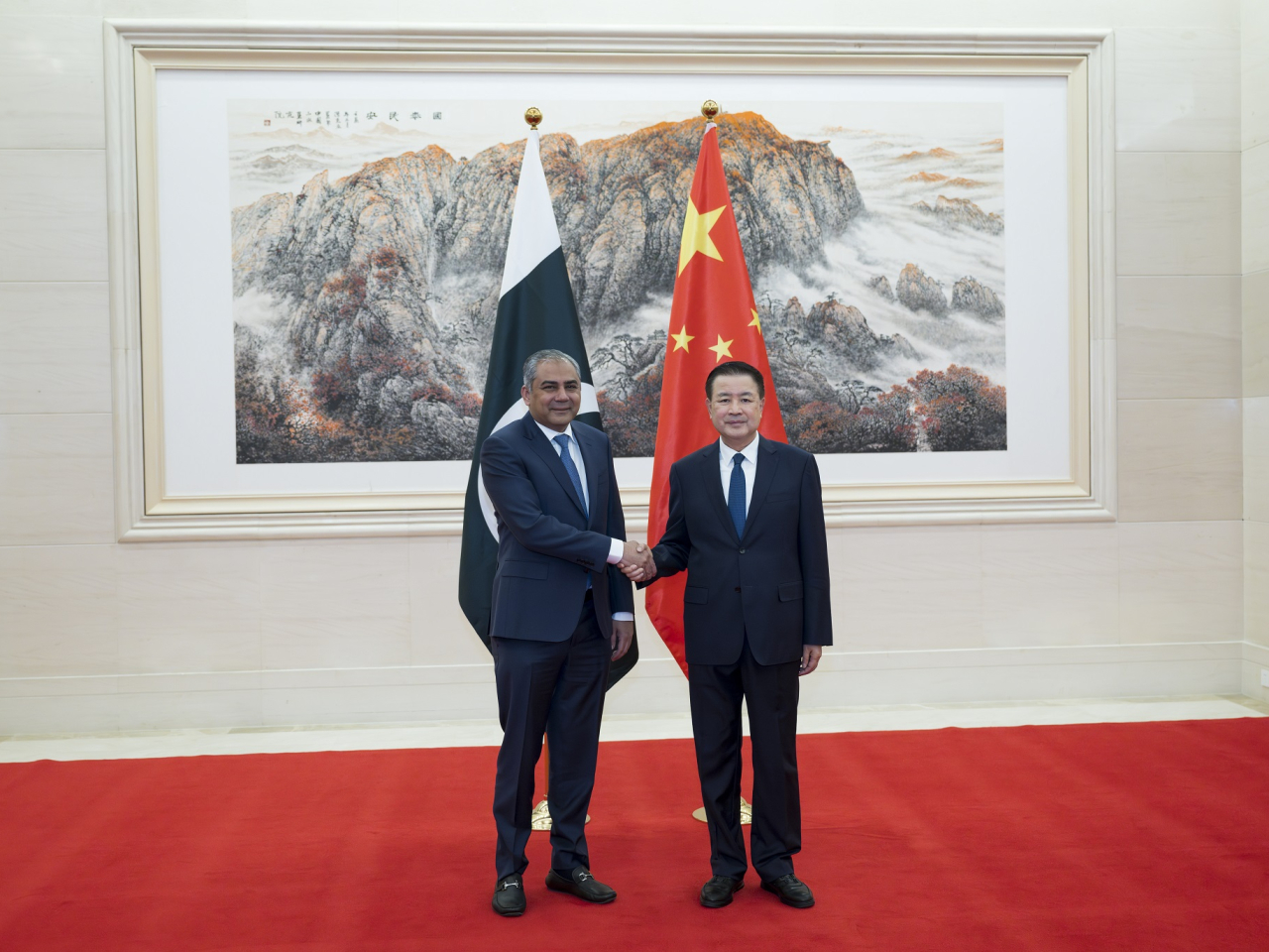 王小洪（右）在北京與納克維 （左）會面。（新華社）