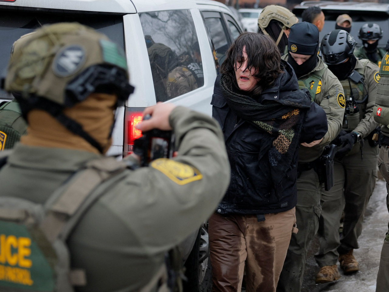 US Border Patrol Agents detain a protestor, a day after the fatal shooting of Renee Nicole Good. Photo: Reuters