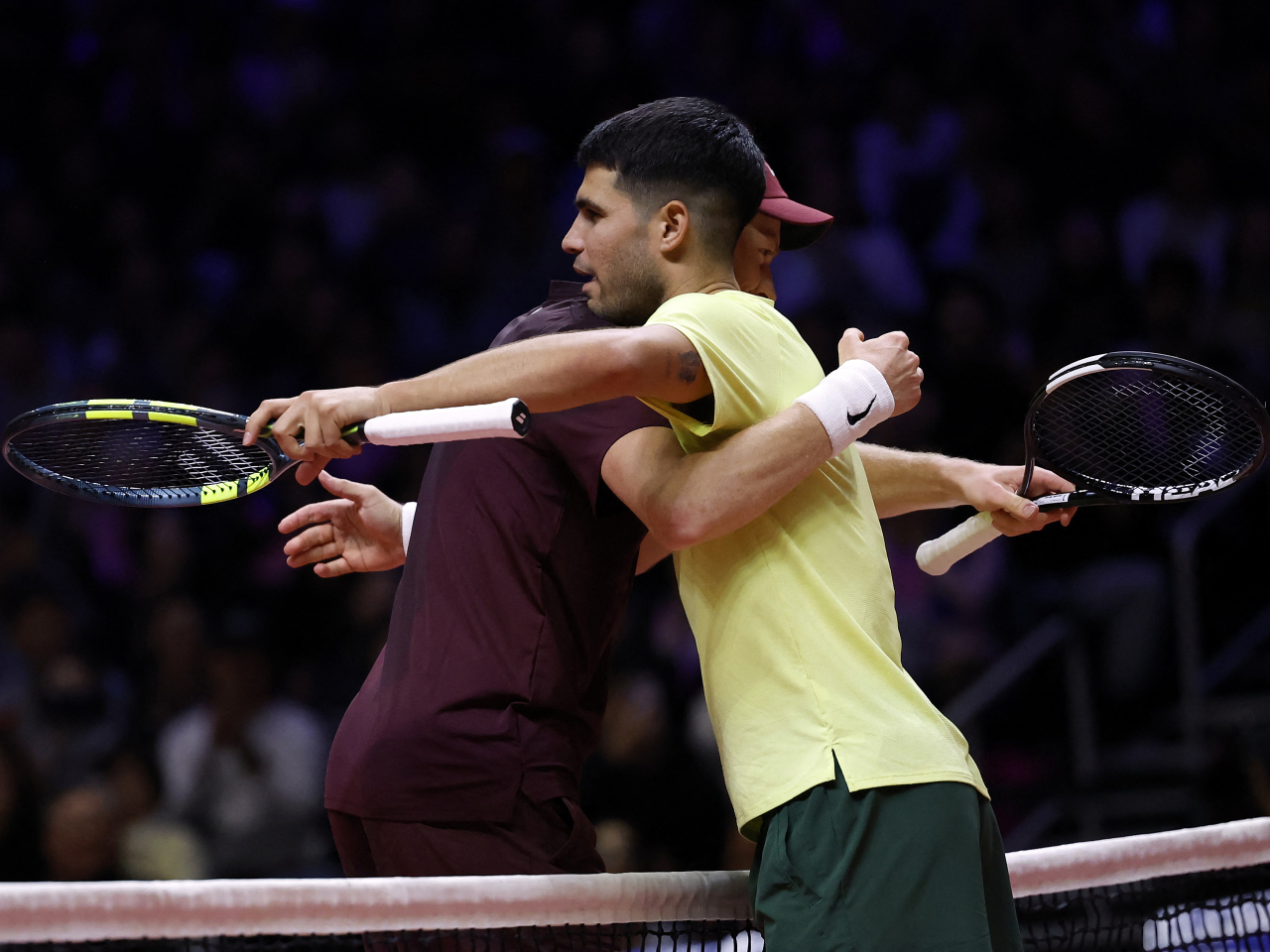 Jannik Sinner and Carlos Alcaraz end their exhibition match with a hug in Incheon, with things set to get serious at the Australian Open soon. Photo: Reuters