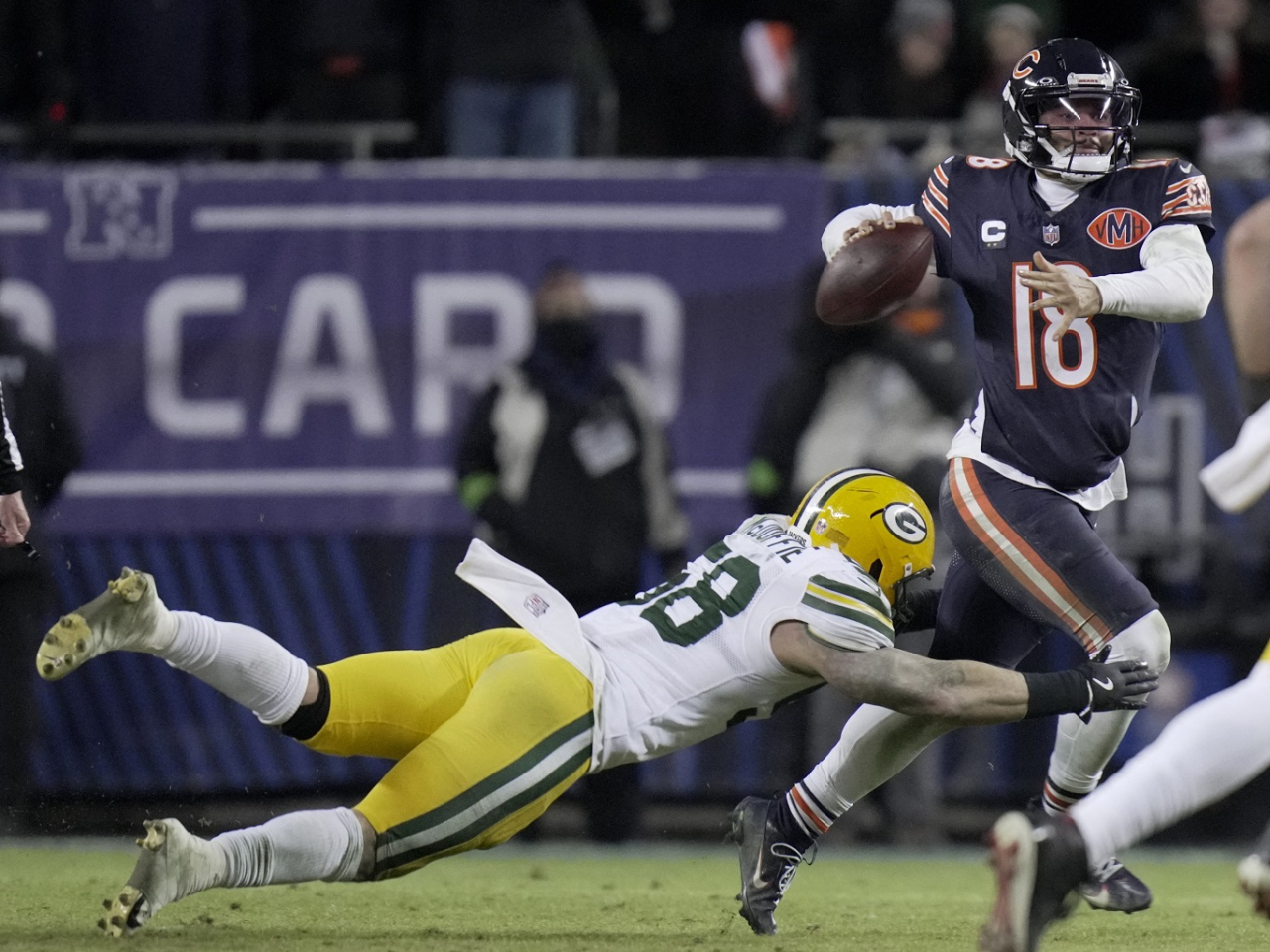 Bears quarterback Caleb Williams, right, avoids a tackle by Green Bay Packers linebacker Isaiah McDuffie. Williams leads Chicago to victory in his playoff debut. Photo: Mark Hoffman/USA TODAY Network via Imagn Images/Reuters