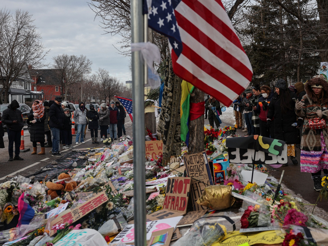 People stand by a makeshift memorial at the scene of the fatal shooting of Renee Nicole Good by a US Immigration and Customs Enforcement (ICE) agent in Minneapolis. Photo: Reuters
