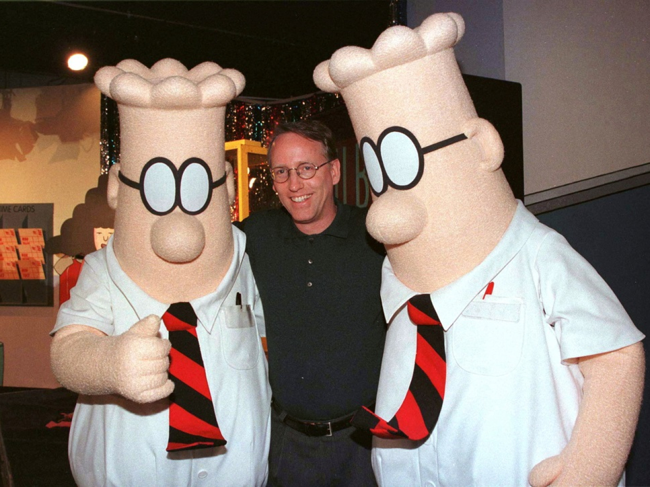 Scott Adams poses with two "Dilbert" characters at a party in January 1999. File photo: Reuters