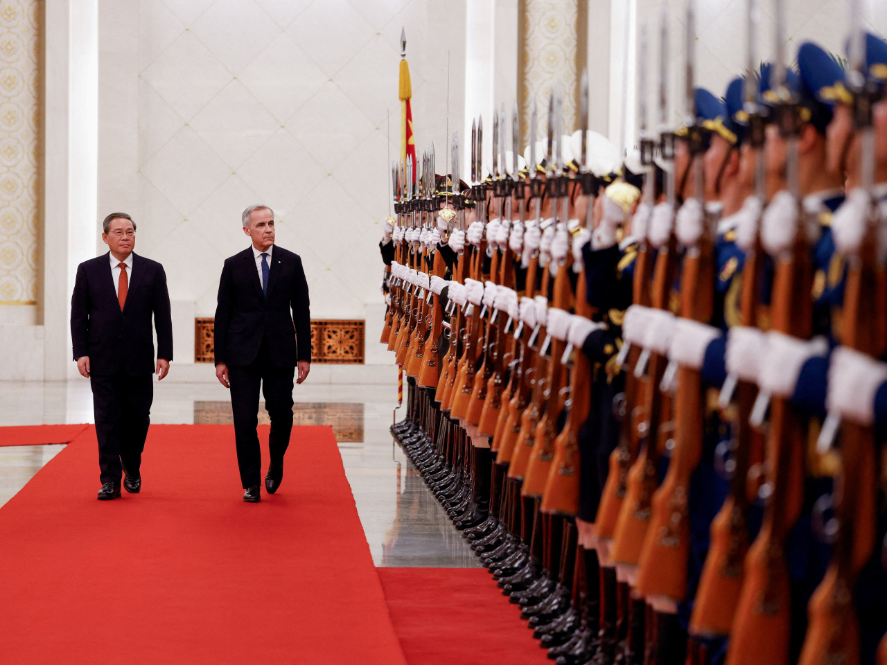 Premier Li Qiang and Canada's Prime Minister Mark Carney review the honour guard at an official welcoming ceremony at the Great Hall of the People. Photo: Reuters