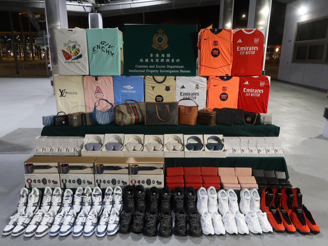 Suspected fake-brand handbags, T-shirts, shoes and headphones were among the goods seized by customs. Photo courtesy of Information Services Department