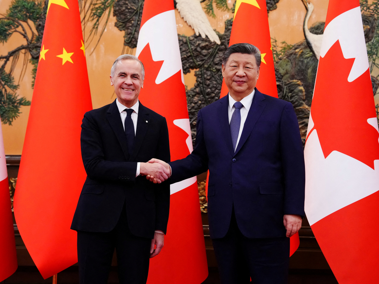 Mark Carney and Xi Jinping seal the improvement in bilateral ties with a handshake in the Great Hall of the People in Beijing. Photo: Reuters