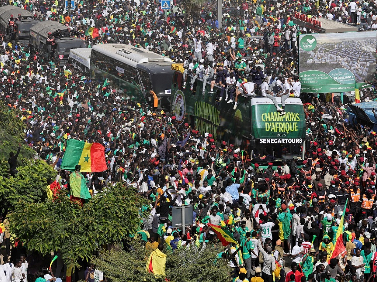 Huge crowds followed the open-top bus as it inched its way across the capital. Photo: Reuters