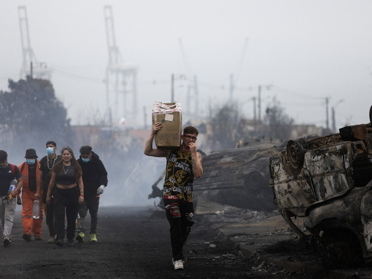 Local residents assist with debris clearance in the aftermath of a forest fire in the Biobio region. Photo: Reuters
