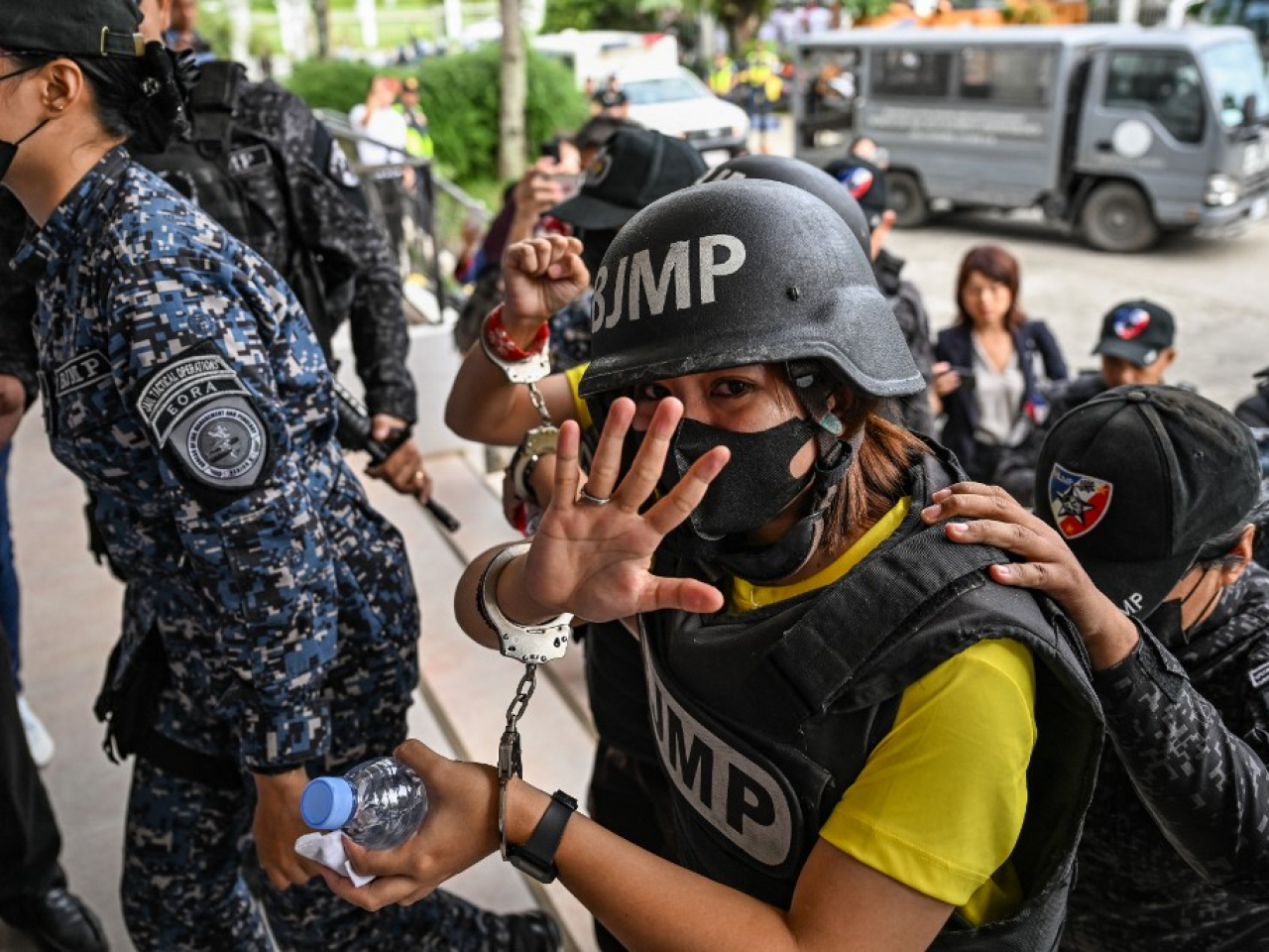 Frenchie Cumpio waves as she arrives at the court in Leyte Island for a verdict that critics have denounced as trumped up to silence critical reporting. Photo: AFP