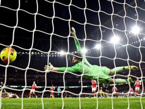 Gunners keeper David Raya can only watch as Matheus Cunha's rasping shot curls inside his far post. Photo: Reuters