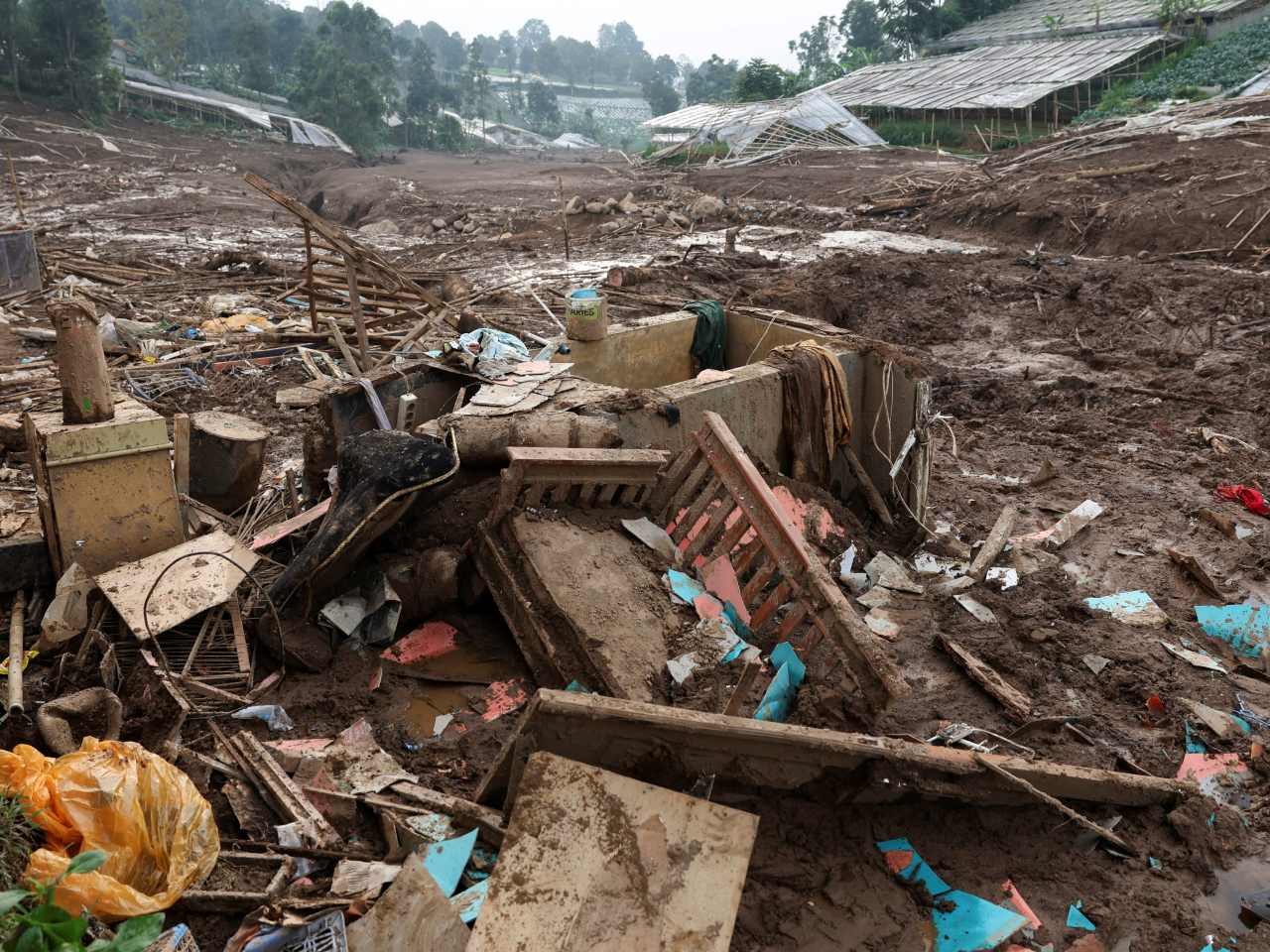 The flow of soil and debris barrelled through Java's West Bandung region on Saturday, burying residential areas and forcing dozens to evacuate their homes. Photo: Reuters