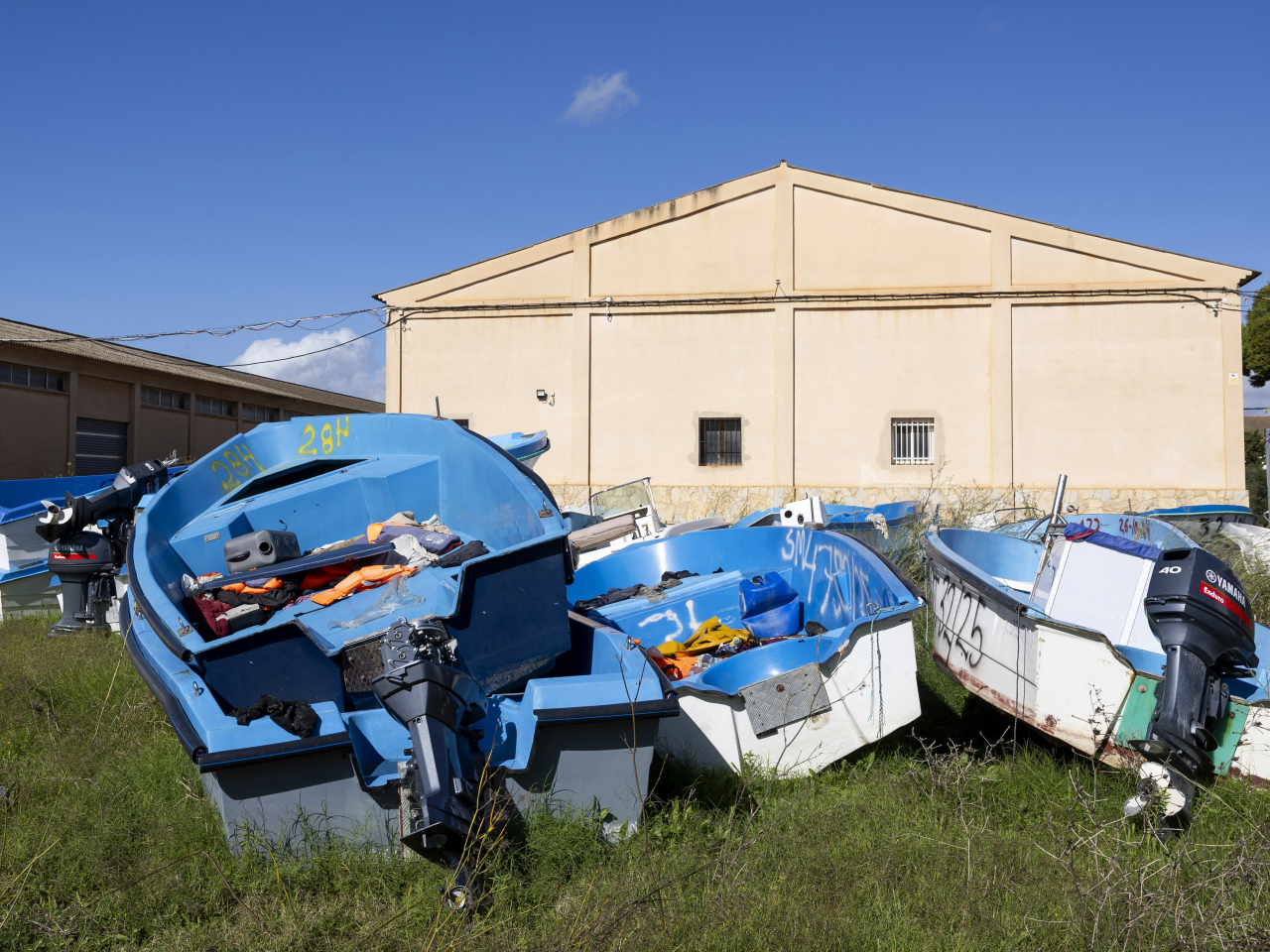 Small migrant boats, used primarily by migrants on their sea route from Algeria to the Balearic Islands, are piled up at a government deposit in Palma de Mallorca. File photo: AFP