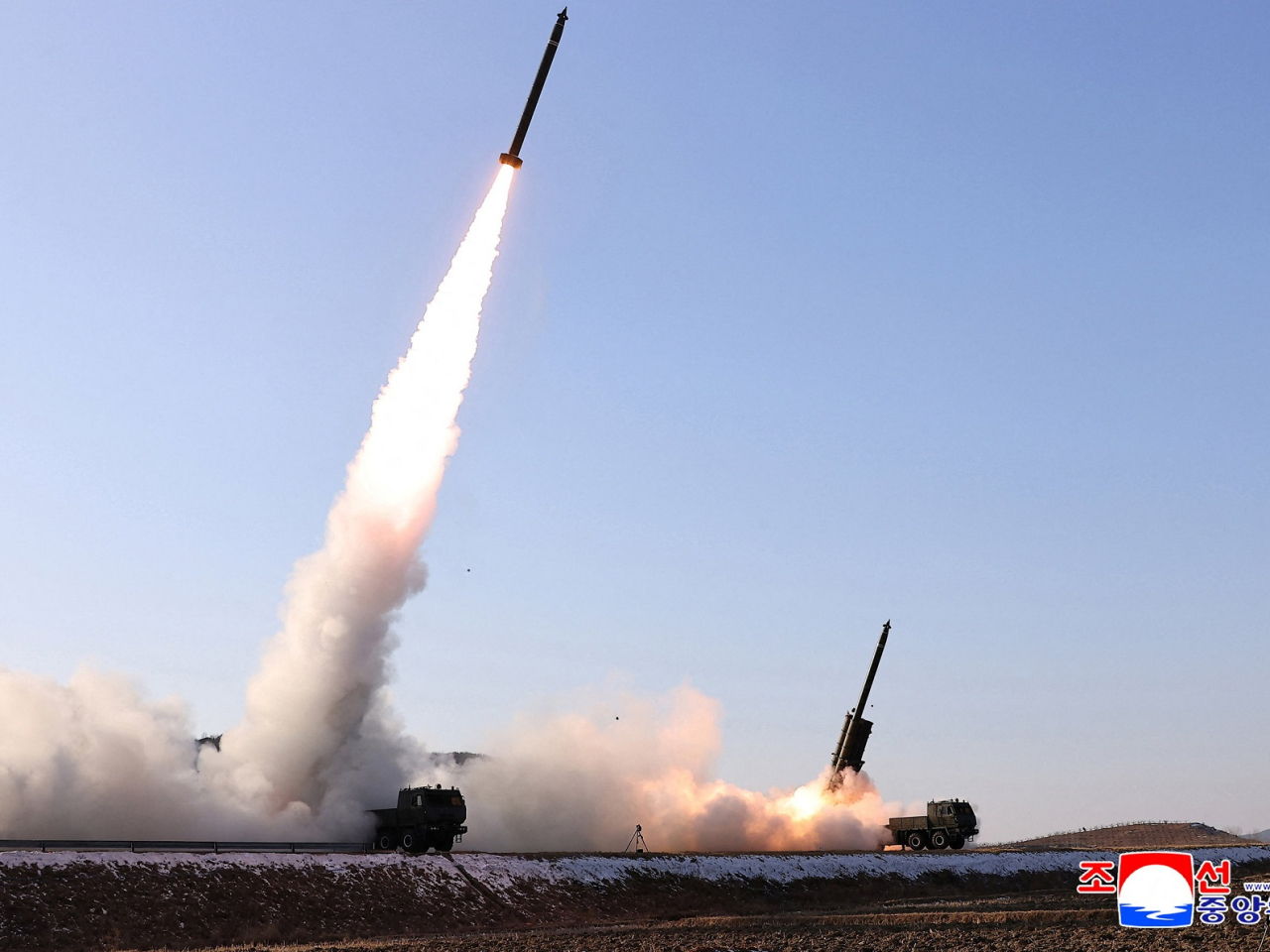 DPRK leader Kim Jong Un directs a test of a large-caliber multiple-rocket launch system in an unknown location in North Korea. Photo: KCNA via Reuters