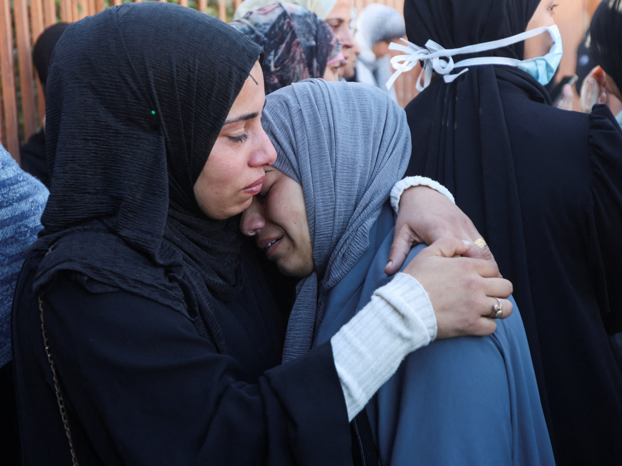 Two Palestinians mourn at Nasser Hospital in Khan Younis during a funeral for people killed in an Israeli strike. Photo: Reuters