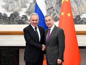 Foreign Minister Wang Yi shook hands with Russian Security Council Secretary Sergei Shoigu as they met in Beijing for talks on Sunday. Photo: Xinhua
