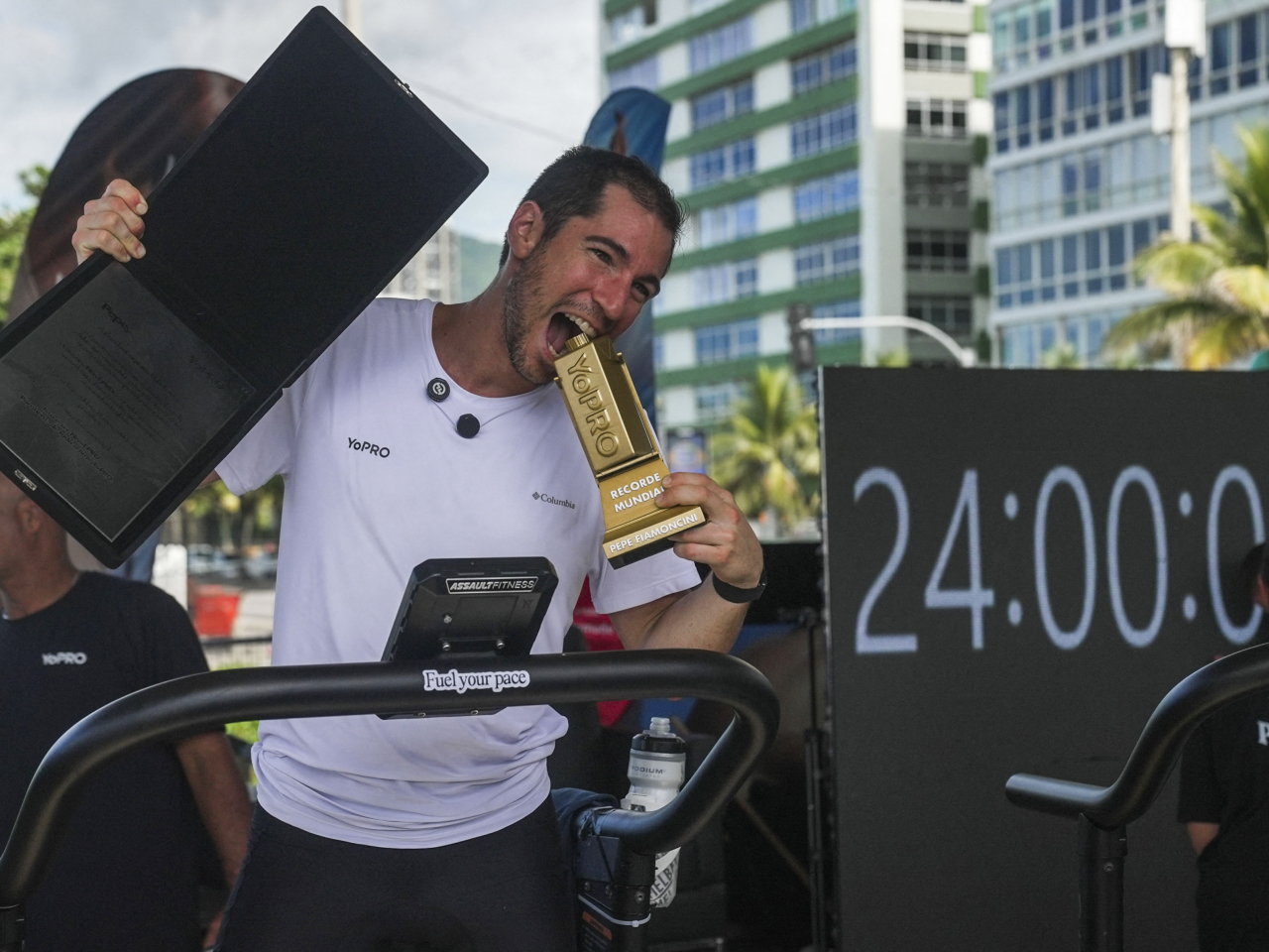 Brazilian athlete Pepe Fiamoncini celebrates after completing his challenge of running 188 km in 24 hours on a treadmill. Photo: AFP