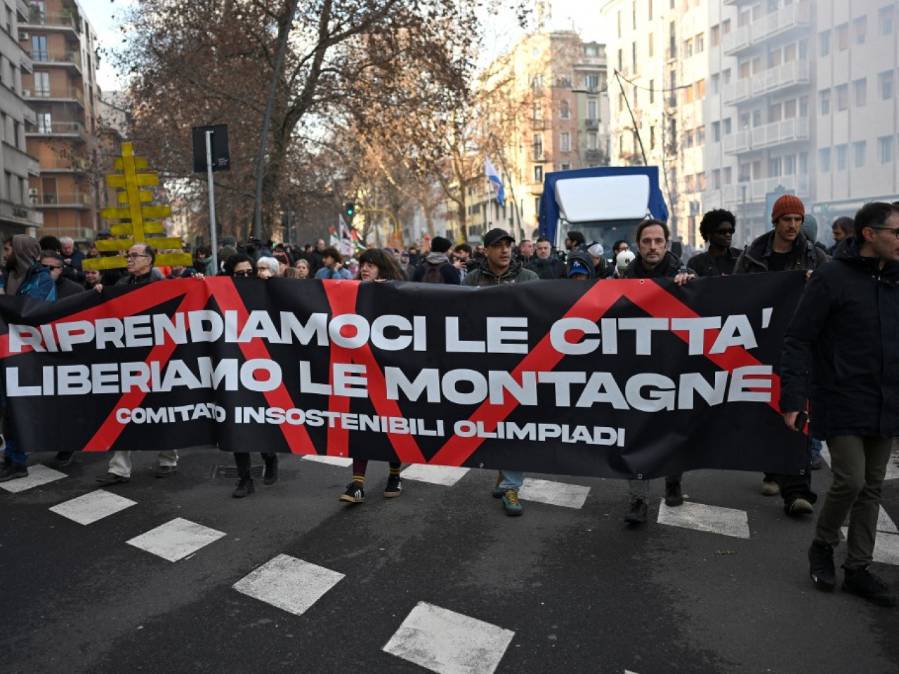 "Let's take back the city, free the mountains!" read the protesters' banner. Photo: AFP