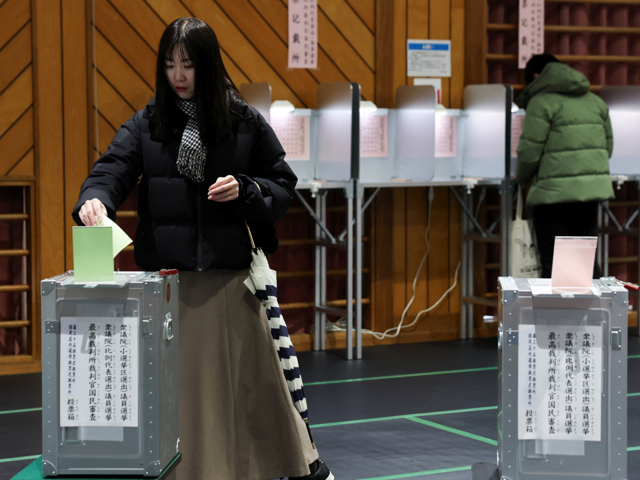 A voter casts her ballot for the general election at a polling station in Tokyo. Photo: Reuters