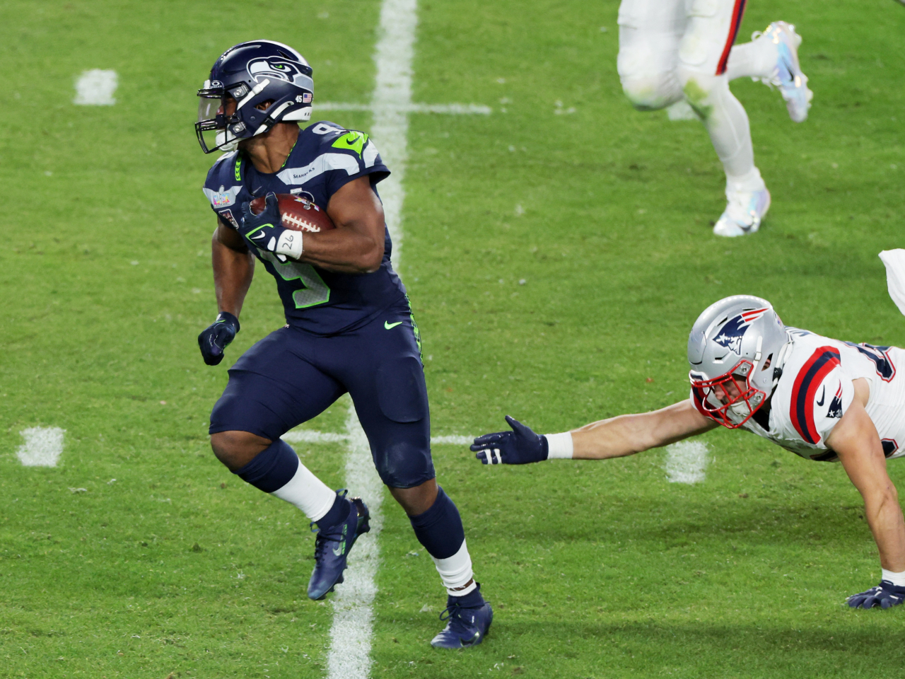Seattle Seahawks' Kenneth Walker III evades Chad Muma of the New England Patriots. Photo: Reuters
