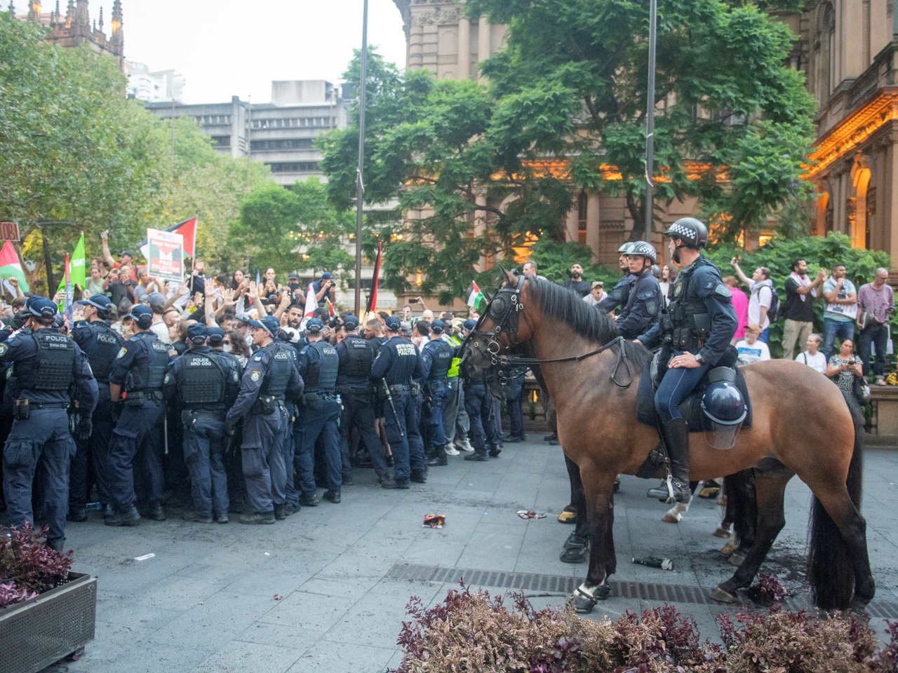 The lines are drawn between pro-Palestinian protesters and police at Town Hall Square in Sydney. Photo: Reuters