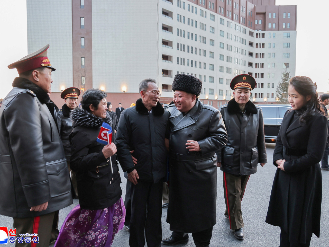 Kim Jong-un and daughter Ju-ae with the parents of one of the killed soldiers at the new housing district in Pyongyang. Photo: Reuters