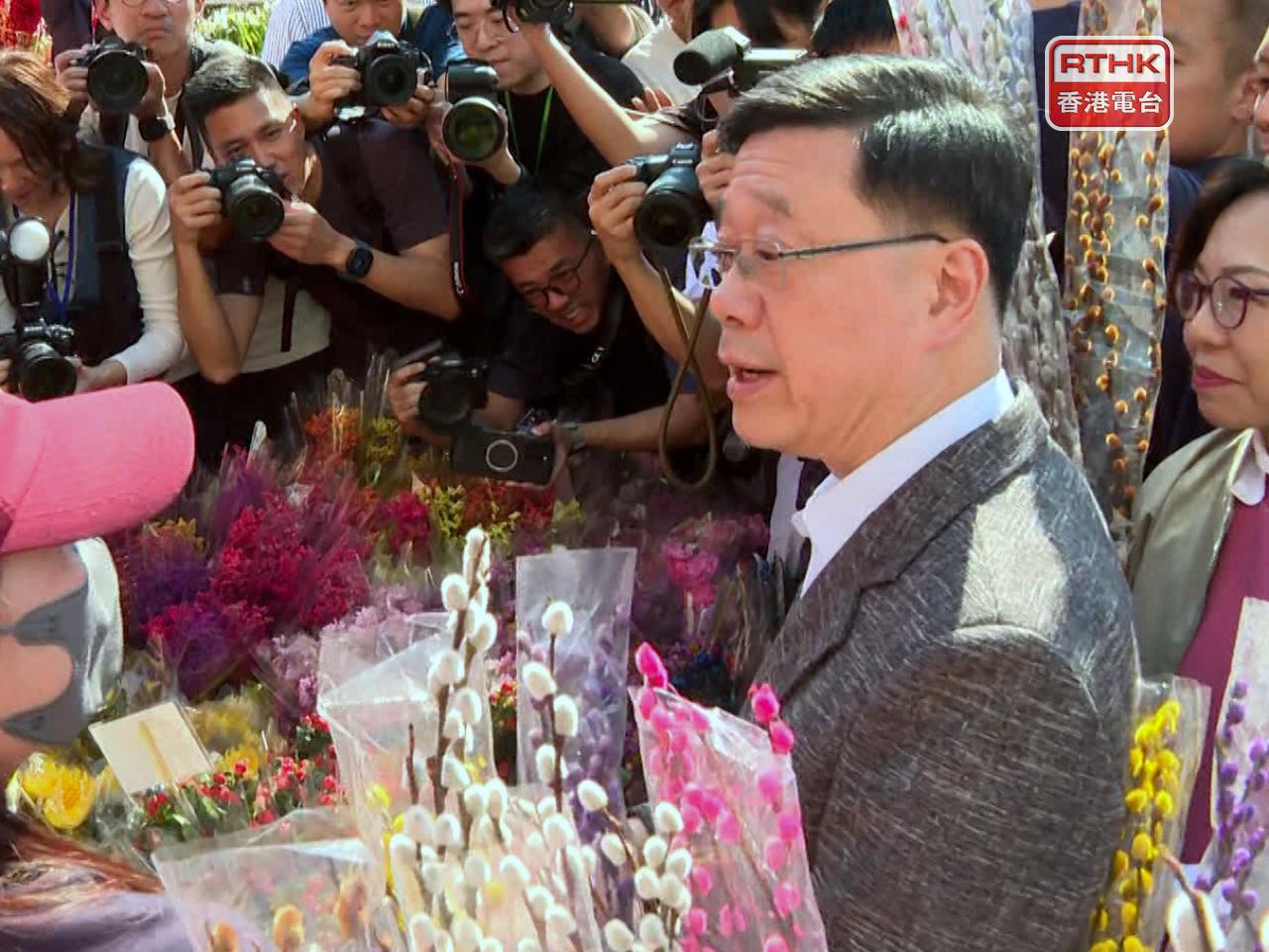 The chief executive greeted stall owners and members of the public during his visit to a Kwun Tong fair. Photo: RTHK