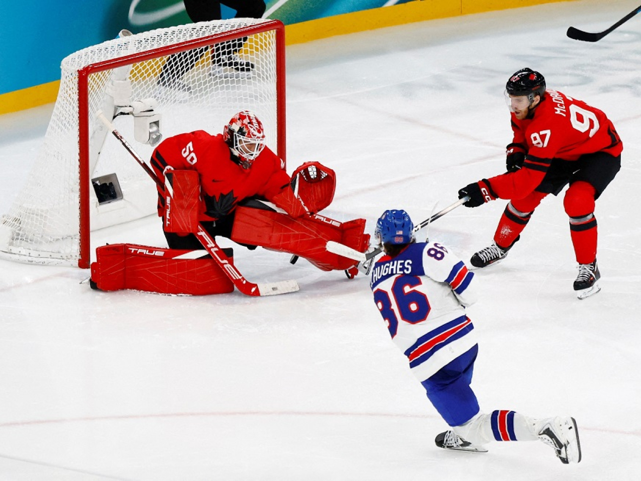 Jack Hughes strikes gold for the USA to win the final in overtime. Photo: Reuters