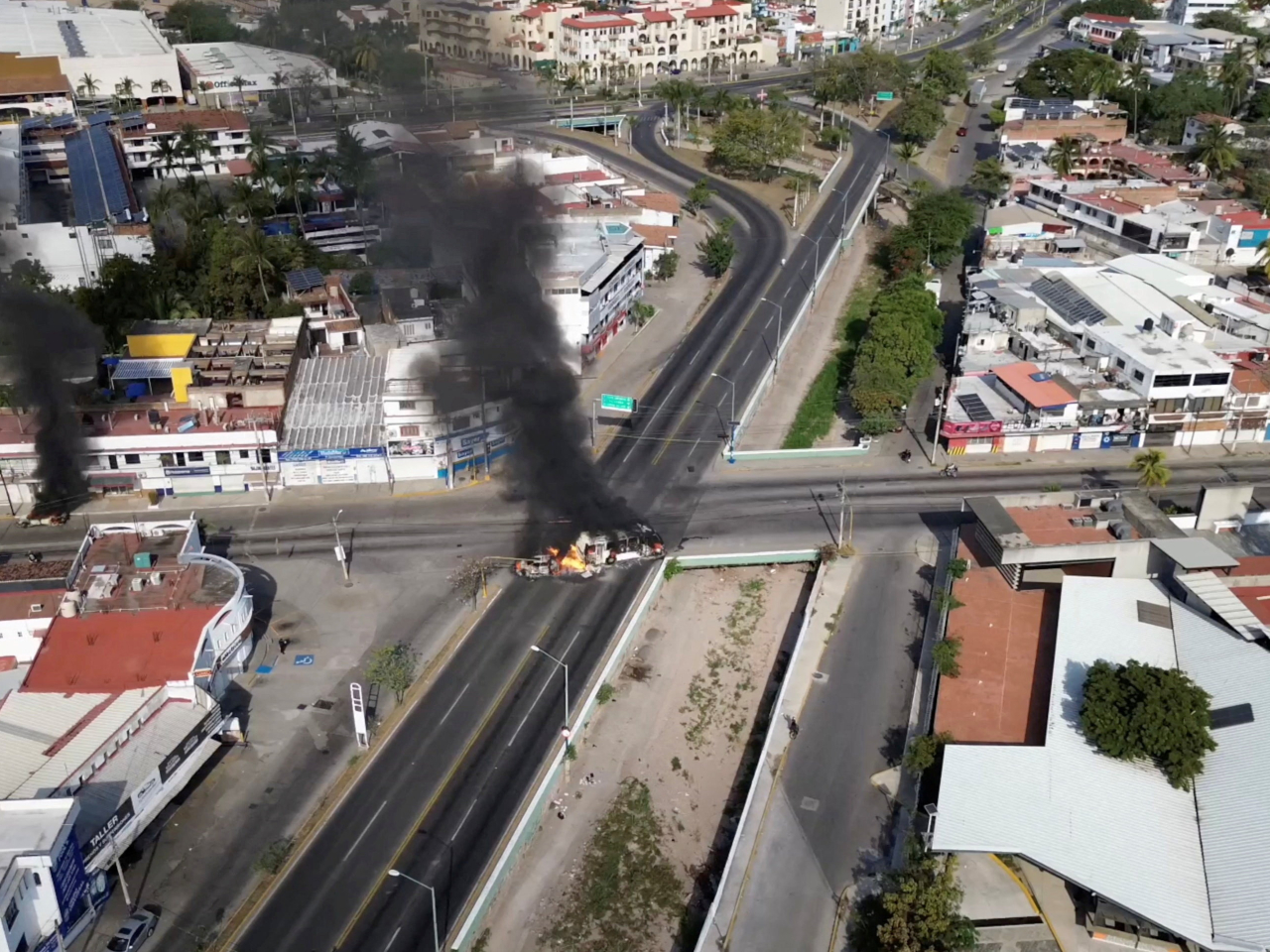 Smoke billows from torched vehicles in Puerto Vallarta, Jalisco, amid a wave of violence in half a dozen states. Photo: @morelifediares via Instagram/Reuters