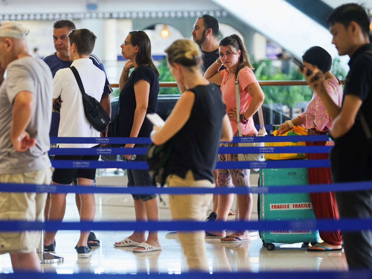 Passengers are stranded at I Gusti Ngurah Rai International Airport in Kuta, Bali, Indonesia, after flights to Doha, Dubai and Abu Dhabi are cancelled. Photo: Reuters