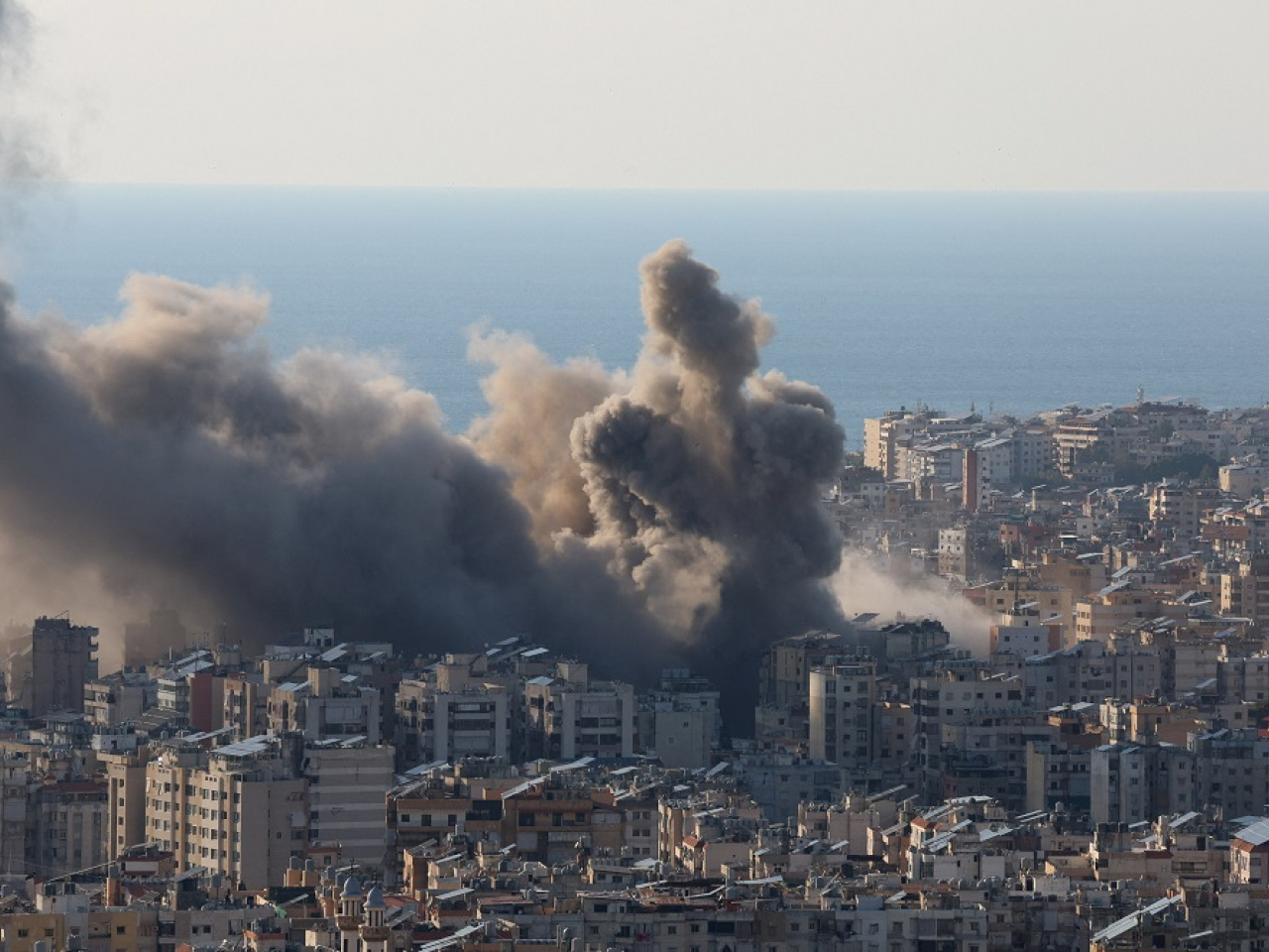 Smoke and dust rise after an Israeli strike on Beirut's southern suburbs, following an escalation between militant group Hezbollah and Israel. Photo: Reuters