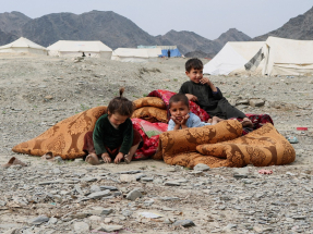Afghan children sit outside their makeshift tent as they take refuge in Lal Pur district. Photo: Reuters