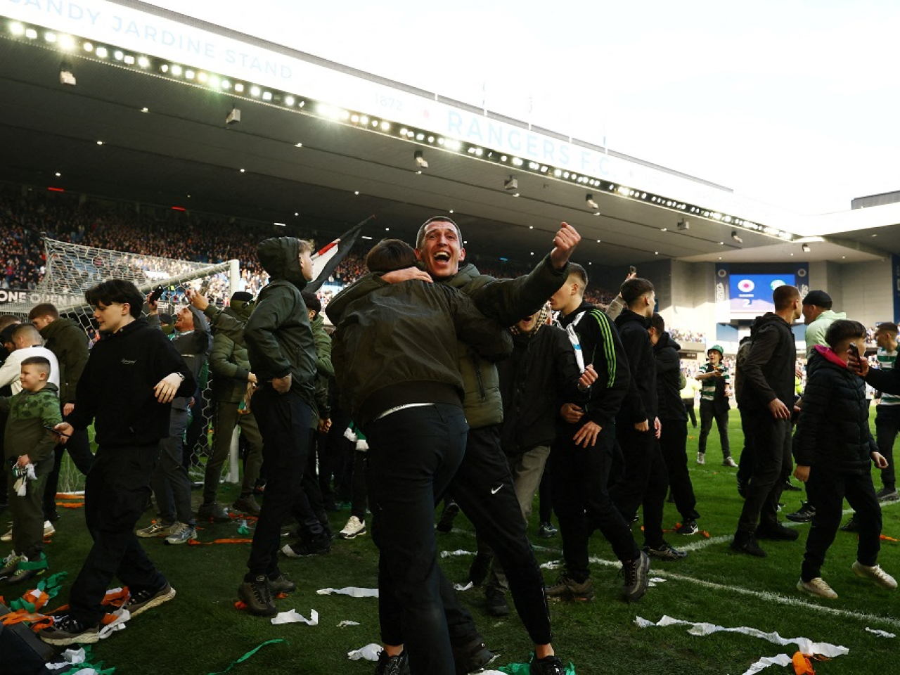 Dozens of Hoops fans spilled onto the pitch to celebrate and taunt the home fans at Ibrox after Celtic beat bitter rivals Rangers in a penalty shootout. Photo: Reuters