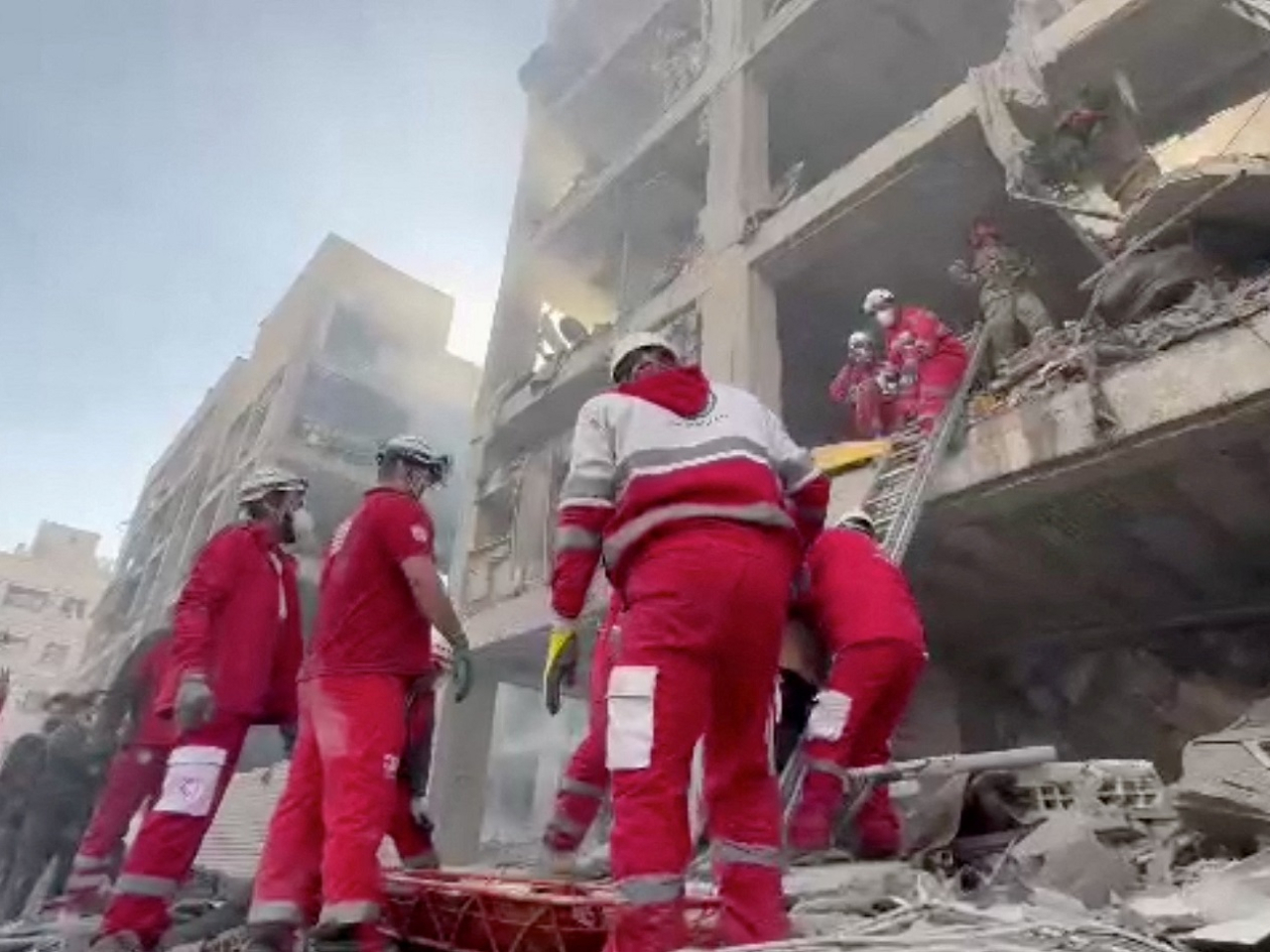 Rescuers look for survivors after air strikes hit the Resalat neighbourhood in Tehran. Photo: Iranian Red Crescent Society via Reuters