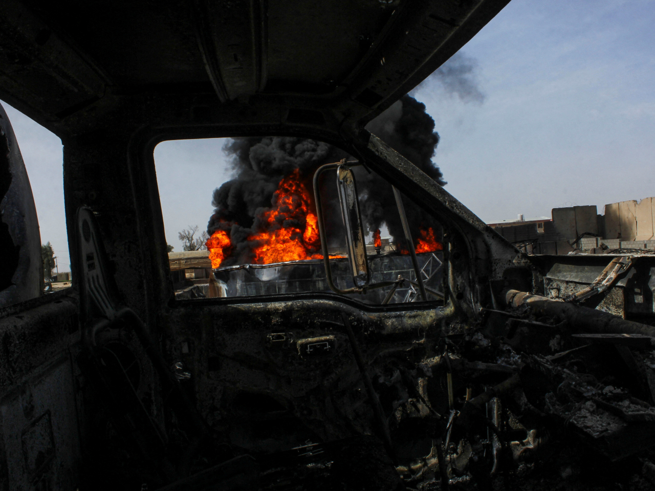 Thick smoke rises from a fuel tank following a Pakistani strike on a Kam Air depot in Kandahar, Afghanistan. Photo: Reuters