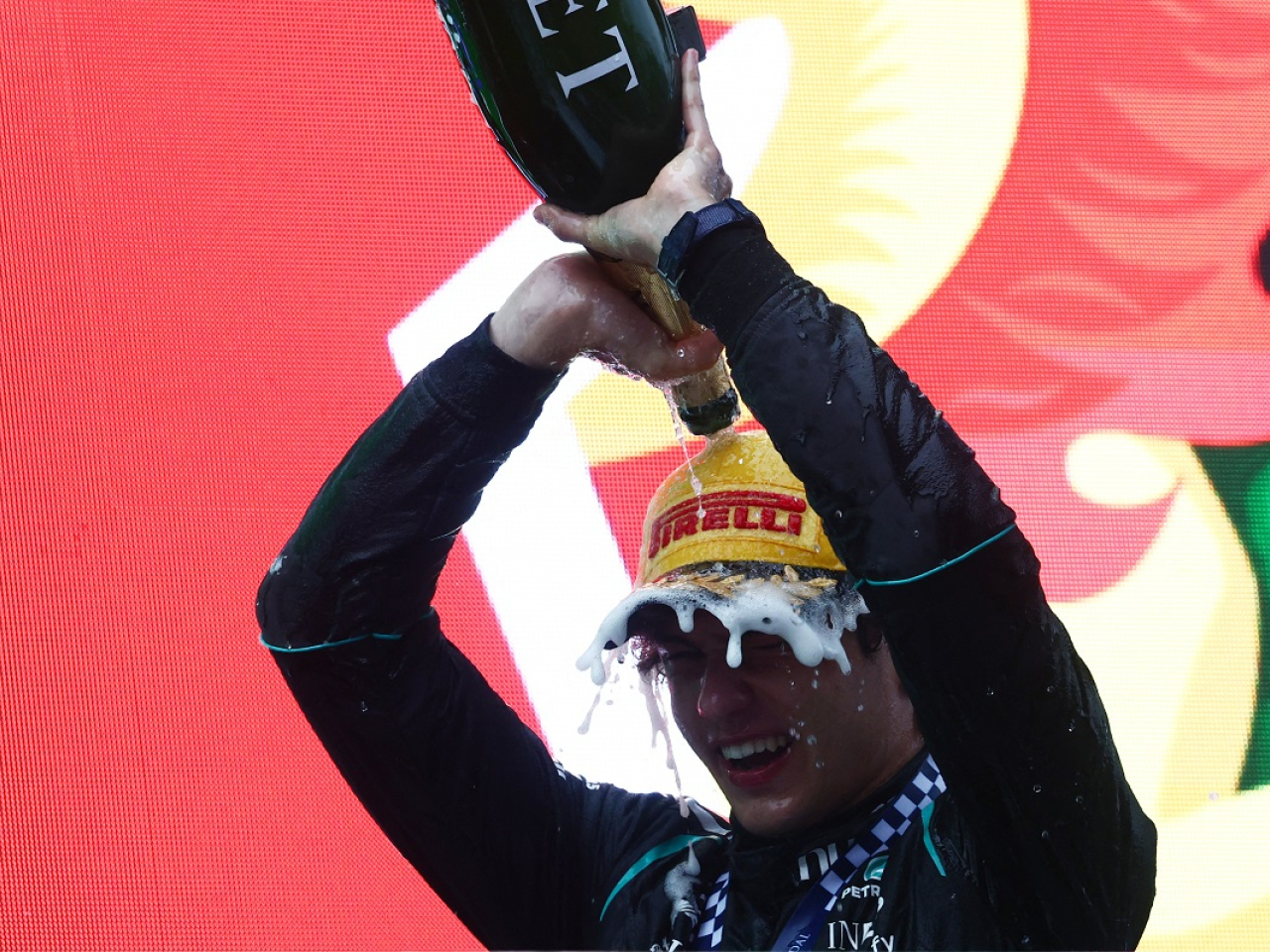 Kimi Antonelli celebrates with champagne on the podium after winning the Chinese Grand Prix in Shanghai. Photo: Reuters