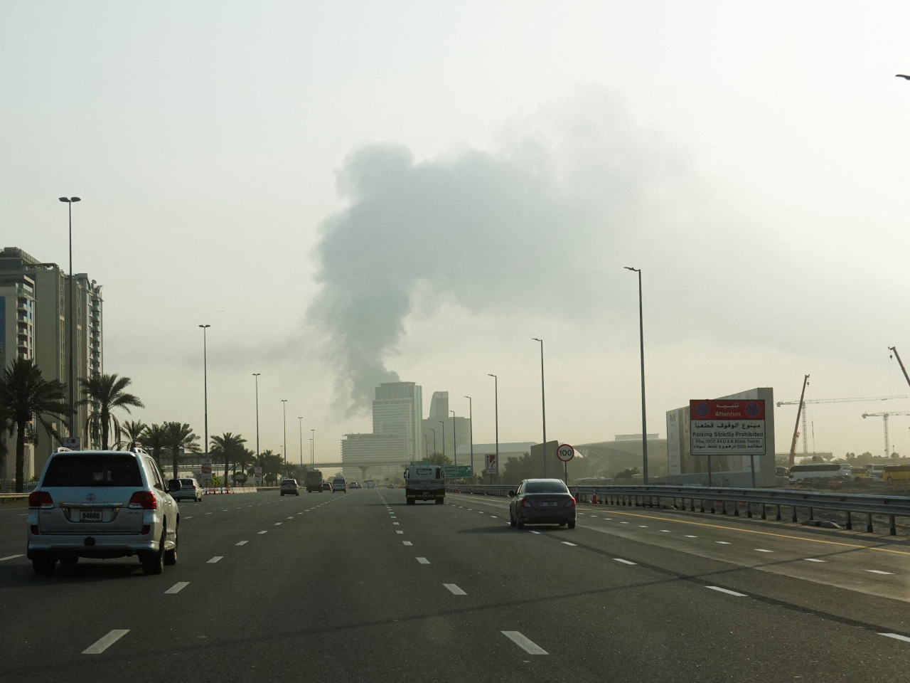 Smoke rises from an area near Dubai International Airport after a drone attack hit a fuel tank. Photo: Reuters