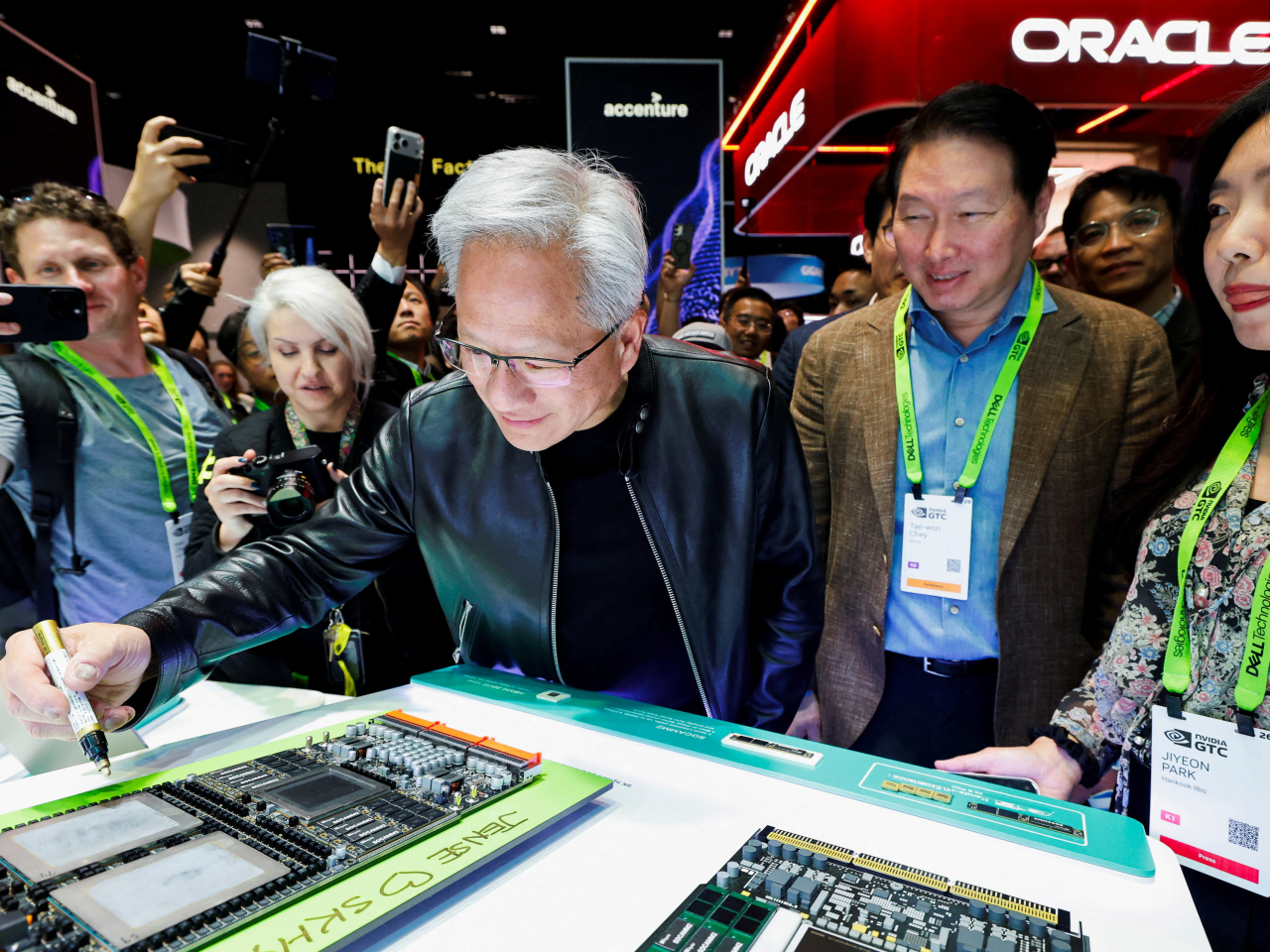 Jensen Huang makes his mark on an integrated circuit at the Nvidia GTC conference in San Jose, California. Photo: Reuters