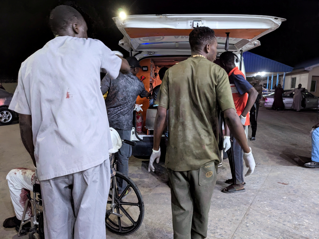 Nigerian Red Cross members assist the wounded into an ambulance after multiple explosions rock northeastern Maiduguri. Photo: Reuters