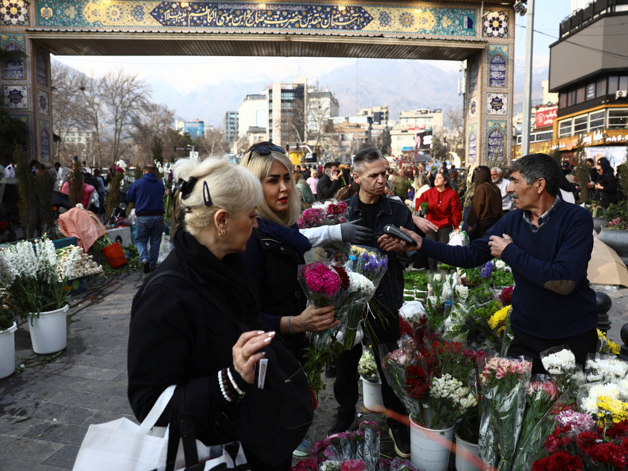 Tehran residents shop at a bazaar ahead of Nowruz, the Iranian New Year, as the threat of US-Israeli airstrikes looms large. Photo: Reuters