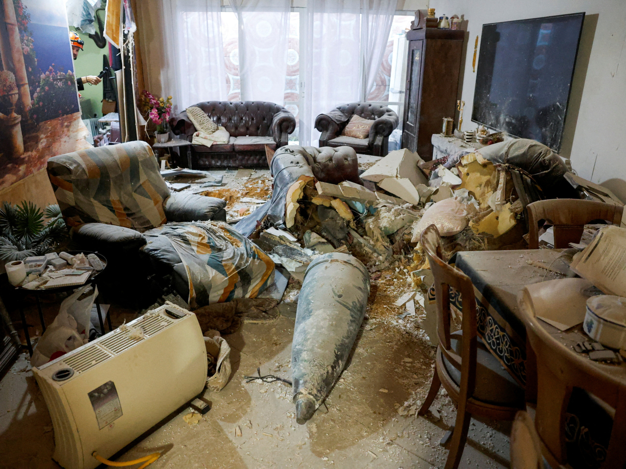 The nose cone of an Iranian missile brings home the realities of military conflict to the living room of a family in Rehovot, Israel. Photo: Reuters