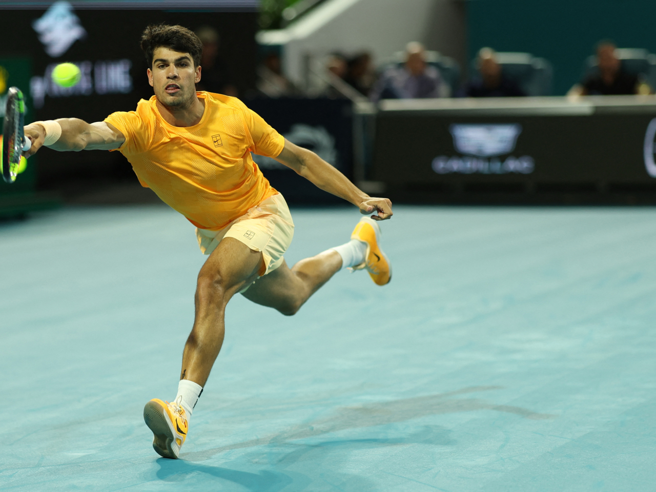 Carlos Alcaraz tries to hit a running shot return against Joao Fonseca at the Hard Rock Stadium in Miami. Photo: Geoff Burke-Imagn Images/Reuters