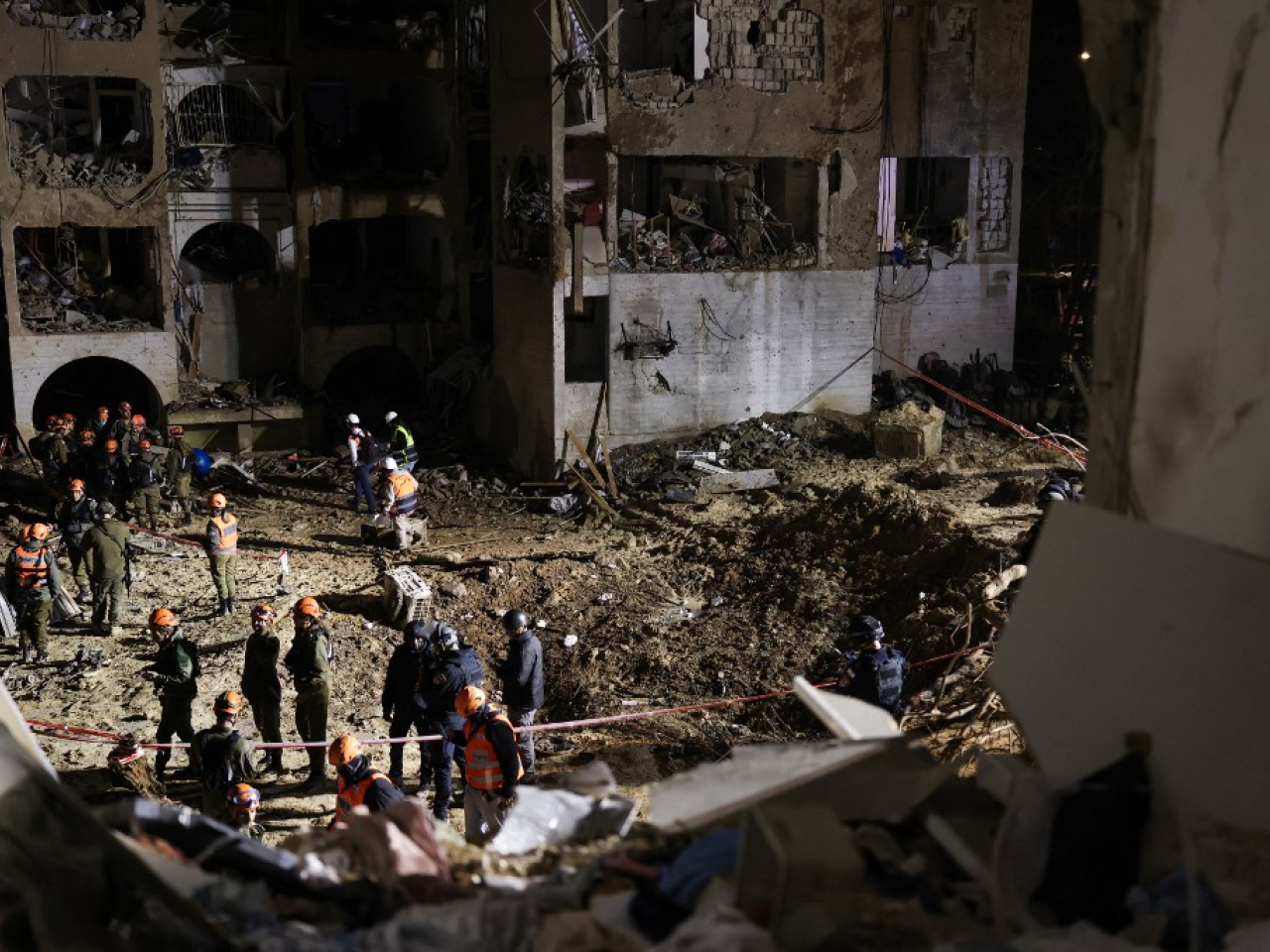 First responders inspect the site of an Iranian missile attack on Arad. Photo: AFP